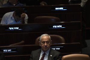 FILE - Israeli Prime Minister designate Benjamin Netanyahu, center, pauses during a session after Yariv Levin was selected as Speaker of the Knesset, Israel's parliament, in Jerusalem, Tuesday, Dec. 13, 2022.