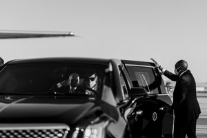 A US Secret Service agent holds the door as Joe Biden boards the Presidential motorcade at Airport in Brussels