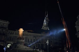 Workers remove the monument to Catherine II, also known as the "Monument to the Founders of Odesa" in Odesa, Ukraine, early Thursday, Dec. 29, 2022. The decision to dismantle the monument consisting of sculptures of Russian Empress Catherine II and her associates was made recently by Odesa residents by electronic voting.