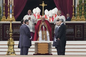 Pope Francis, centre, sits by the coffin of late Pope Emeritus Benedict XVI St. Peter's Square during a funeral mass at the Vatican, Thursday, Jan. 5, 2023