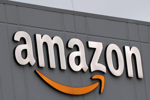 A sign is lit on the facade of an Amazon fulfillment center, Thursday, March 19, 2020, on Staten Island in New York