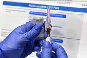 In this Monday, July 27, 2020 file photo, a nurse prepares a shot as a study of a possible COVID-19 vaccine, developed by the National Institutes of Health and Moderna Inc., gets underway in Binghamton