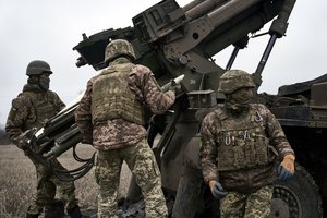 Ukrainian soldiers prepare to fire a French-made CAESAR self-propelled howitzer towards Russian positions near Avdiivka, Donetsk region, Ukraine, Monday, Dec. 26, 2022