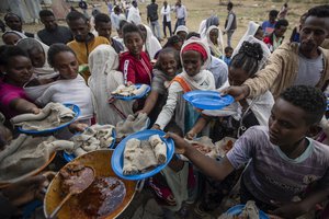 File: Displaced Tigrayans queue to receive food donated by local residents at a reception center for the internally displaced in Mekele, in the Tigray region of northern Ethiopia Sunday, May 9, 2021.