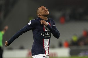 PSG's Kylian Mbappe reacts during the French League One soccer match between Lens and Paris Saint-Germain at the Bollaert stadium in Lens, France Sunday, Jan. 1, 2023.