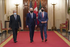 President Joe Biden walks with Mexican President Andrés Manuel López Obrador and Canadian Prime Minister Justin Trudeau to a meeting in the East Room of the White House in Washington, Thursday, Nov. 18, 2021