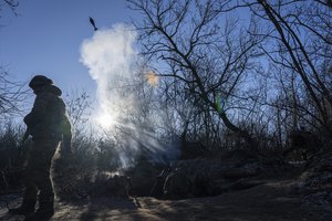 Ukrainian servicemen fire a 120 mm mortar towards Russian positions at the frontline near Bakhmut, Donetsk region, Ukraine, Wednesday, Jan. 11, 2023.