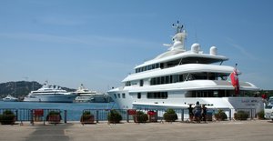 Three luxury yachts (or superyachts) - Lady Anne, Lady Moura and Pelorus within the port of Porto Cervo, Italy. They all belong to the 100 largest luxury yachts.