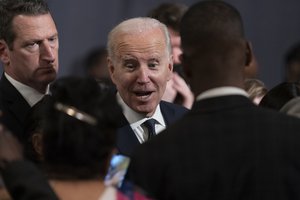 President Joe Biden talks to participants after speaking at the National Action Network's Martin Luther King, Jr., Day breakfast, Monday, Jan. 16, 2023, in Washington.