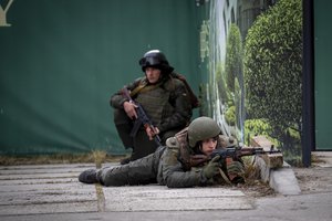 FILE - Ukrainian soldiers take positions in downtown Kyiv, Ukraine, Feb. 25, 2022.