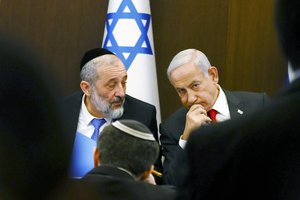 Israeli Prime Minister Benjamin Netanyahu, right, speaks with Interior and Health Minister Aryeh Deri at a weekly cabinet meeting at the Prime Minister's office in Jerusalem, Sunday, Jan. 8, 2023.