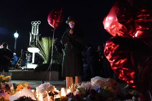 A woman pauses at a memorial at a vigil honoring the victims of a shooting at the Star Ballroom Dance Studio on Monday, Jan. 23, 2023, in Monterey Park, Calif. A gunman killed multiple people late Saturday amid Lunar New Years celebrations in the predominantly Asian American community.