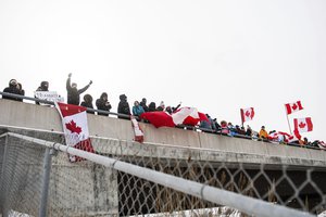 Protestors show their support for the Freedom Convoy of truck drivers who are making their way to Ottawa to protest against COVID-19 vaccine mandates by the Canadian government on Thursday, Jan. 27, 2022, in Vaughan.