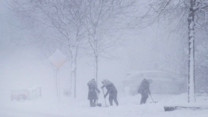 People shovel their driveways in a blizzard in Mississauga, Ont., on Wednesday, Jan. 25, 2023. THE CANADIAN PRESS/Nathan Denette