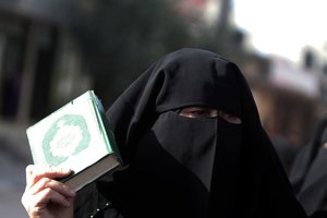 Relatives of Salafist prisoners being held by Hamas hold an Al-Qaeda-affiliated flag during a demonstration calling for their release in Rafah in the southern Gaza Strip on April 6, 2013. The Islamist movement Hamas, which has ruled the Gaza Strip since 2007, has regularly cracked down on hardline Salafists in the territory, notably in 2009.P Photo by Photo by Ahmed Deeb / WN