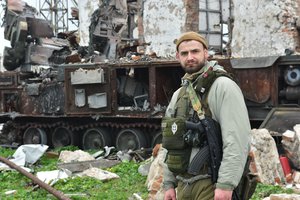 File - A Ukrainian soldier stands in front of destroyed Russian military vehicles on Snake Island, in the Black Sea, Ukraine, Sunday, Dec. 18, 2022.