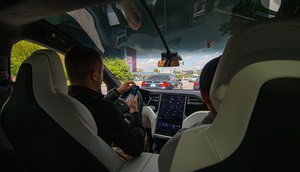 Man driving a Tesla car