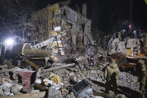 Emergency workers clear the rubble after a Russian rocket hit an apartment building in Kramatorsk, Ukraine, on Thursday, Feb. 2, 2023. At least 3 people were killed and 21 wounded in the attack. (AP Photo/Yevgen Honcharenko)