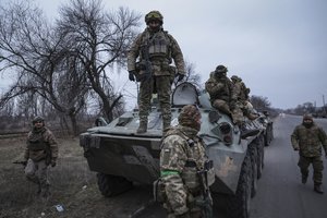 Ukrainian soldiers stand atop on APC before going to the frontline in Donetsk region, Ukraine, Saturday, Jan. 28, 2023.