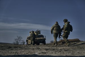 Soldiers of the Ukrainian 3rd Army Assault Brigade of the Special Operations Forces (SSO) "Azov" approach their armoured U.S. Hummer vehicle in position near Bakhmut, Donetsk region, Ukraine, Saturday, Feb. 11, 2023.