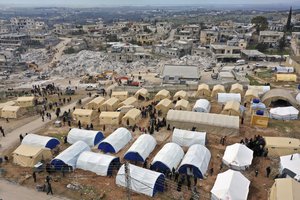 FILE - Volunteers set up tents for Families who lost their homes in a devastating earthquake to provide them shelter and food near destroyed buildings in the town of Harem, Idlib province, Syria, Saturday, Feb. 11, 2023. After years of war, residents of areas in northwest Syria struck by a massive earthquake are grappling with their new and worsening reality.