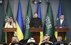 Andriy Yermak, Head of the Office of the President of Ukraine, center, speaks during a joint press conference with Saudi Arabia's Foreign Minister Prince Faisal Bin Farhan Al Saud, left, and Dmytro Kuleba, Foreign Minister of Ukraine, in Kyiv, Ukraine, Sunday, Feb. 26, 2023. (Genya Savilov/Pool Photo via AP)