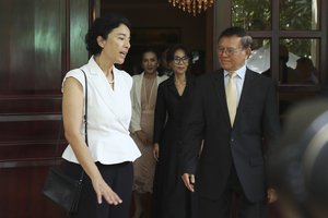 Cambodia National Rescue Party's President Kem Sokha, right, talks with French Ambassador to Cambodia Eva Nguyen Binh, center, at his house in Phnom Penh, Cambodia, Monday, Nov. 11, 2019.