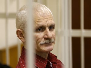 FILE - Ales Bialiatski, the head of Belarusian Vyasna rights group, stands in a defendants' cage during a court session in Minsk, Belarus, on Nov. 2, 2011. A Belarusian court on Thursday Jan. 5, 2023 began the trial of jailed human rights activist Ales Bialiatski, one of the winners of the 2022 Nobel Peace Prize. Bialiatski and two other top figures of the Viasna human rights center which he founded face up to 12 years in prison if convicted on charges of financing anti-government protests. (AP Photo/Sergei Grits, File)