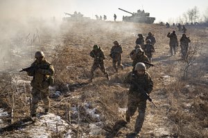 Ukrainian servicemen of the 3rd Separate Tank Iron Brigde take part in an exercise in the Kharkiv area, Ukraine, Thursday, Feb. 23, 2023, the day before the one year mark since the war began. War has been a catastrophe for Ukraine and a crisis for the globe and the world is a more unstable and fearful place since Russia invaded its neighbor on Feb. 24, 2022.