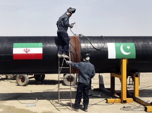 In this March 11, 2013 file photo, Iranian workers weld two gas pipes together at the start of construction on a pipeline to transfer natural gas from Iran to Pakista