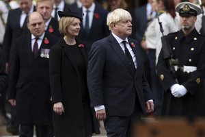 Former British Prime Ministers, Boris Johnson, right, and Liz Truss attend the Remembrance Sunday ceremony at the Cenotaph on Whitehall in London, Sunday Nov. 13, 2022.