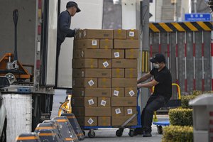 Workers load off boxes containing frozen beefs from a truck for a restaurant at the shopping mall in Beijing on Feb. 27, 2023. Chinese economic officials expressed confidence Monday, March 6, 2023 they can meet this year’s growth target of