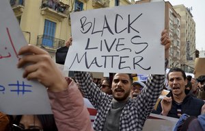 People demonstrate against Tunisian President Kais Saied's comment on migration, Saturday, Feb. 25, 2023 in Tunis