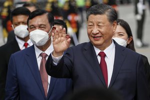 File - Chinese President Xi Jinping waves as they disembark their plane upon arrival at Ngurah Rai International Airport ahead of the G20 Summit in Bali, Indonesia, Monday, Nov. 14, 2022.