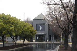 A person walks toward an entrance to Silicon Valley Bank in Santa Clara, Calif., Friday, March 10, 2023.