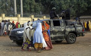 FILE - In this Wednesday, March 3, 2021 file photo, parents are reunited with their daughters who had been kidnapped from their school, in Jangebe, Nigeria.