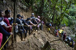 FILE - Migrants, mostly Venezuelans, walk across the Darien Gap from Colombia into Panama, hoping to reach the U.S., on Oct. 15, 2022. The migratory flow through America has not stopped growing during 2022 despite the attempts of governments to control illegal crossings. (AP Photo/Fernando Vergara, File)