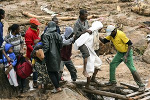 An injured man helped accrossin Blantyre, Malawi, Monday, March 13, 2023