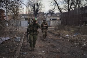 Ukrainian soldiers walk along a street in the area of the heaviest battles with the Russian invaders in Bakhmut, Donetsk region, Ukraine, Wednesday, March 15, 2023