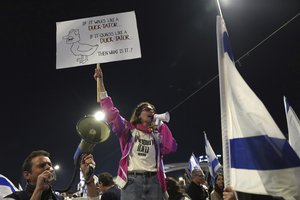 Israelis protest plans by Prime Minister Benjamin Netanyahu's government to overhaul the judicial system, in Tel Aviv, Israel, Saturday, March 11, 2023