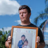 David Fleming holds a picture of his abducted children at his rural property outside of Brisbane.