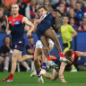 Melbourne’s Kysaiah Pickett ploughs into Bailey Smith on Saturday night at the MCG.