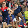 Melbourne’s Kysaiah Pickett ploughs into Bailey Smith on Saturday night at the MCG.