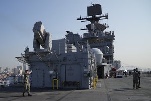 A U.S. Marines personnel gestures at the flight deck of the USS America (LHA 6) during a scheduled port visit in Manila, Philippines on Tuesday, March 21, 2023.