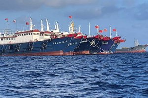 In this March 31, 2021, file photo provided by the National Task Force-West Philippine Sea, Chinese vessels are moored at Whitsun Reef, South China Sea.