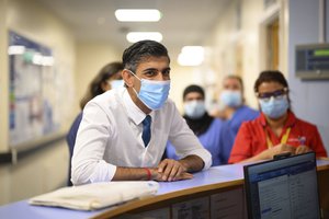 Britain's Prime Minister Rishi Sunak speaks with members of staff as he visits Croydon University hospital, in South London, Friday, Oct. 28, 2022