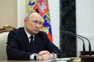 Russian President Vladimir Putin listens to Russian Transport Minister Vitaly Savelyev during their meeting in Moscow, Russia, Saturday, March 25, 2023