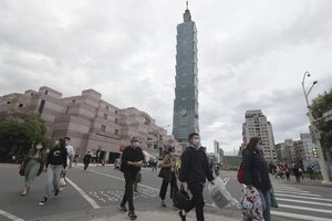 People wear face masks to protect against the spread of the coronavirus in Taipei, Taiwan, Thursday, March 24, 2022.