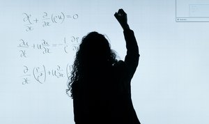 Woman writing on a whiteboard