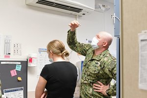 PEARL HARBOR (Dec. 16, 2020) Hospital Corpsman 2nd Class Timothy Maddox, assigned to the Preventive Medicine Department at Naval Health Clinic Hawaii (NHCH), prepares to deliver the first Pfizer-BioNTech COVID-19 vaccine at NHCH by diluting the multi-dose vials, Dec. 16, 2020.